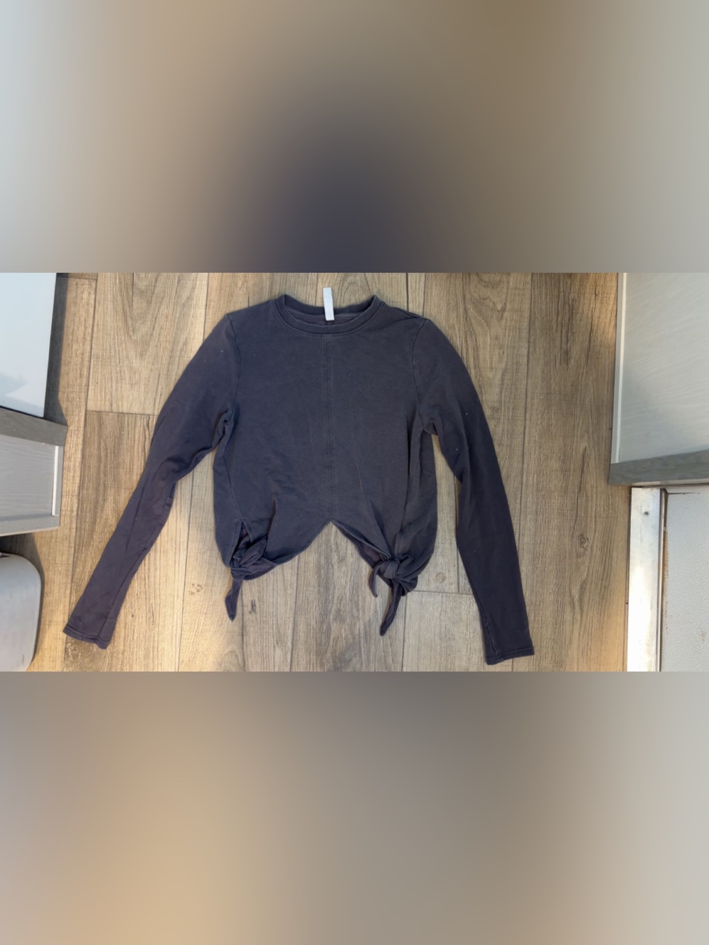 Athleta Charcoal Long sleeve top- with tie details on the bottom; size small